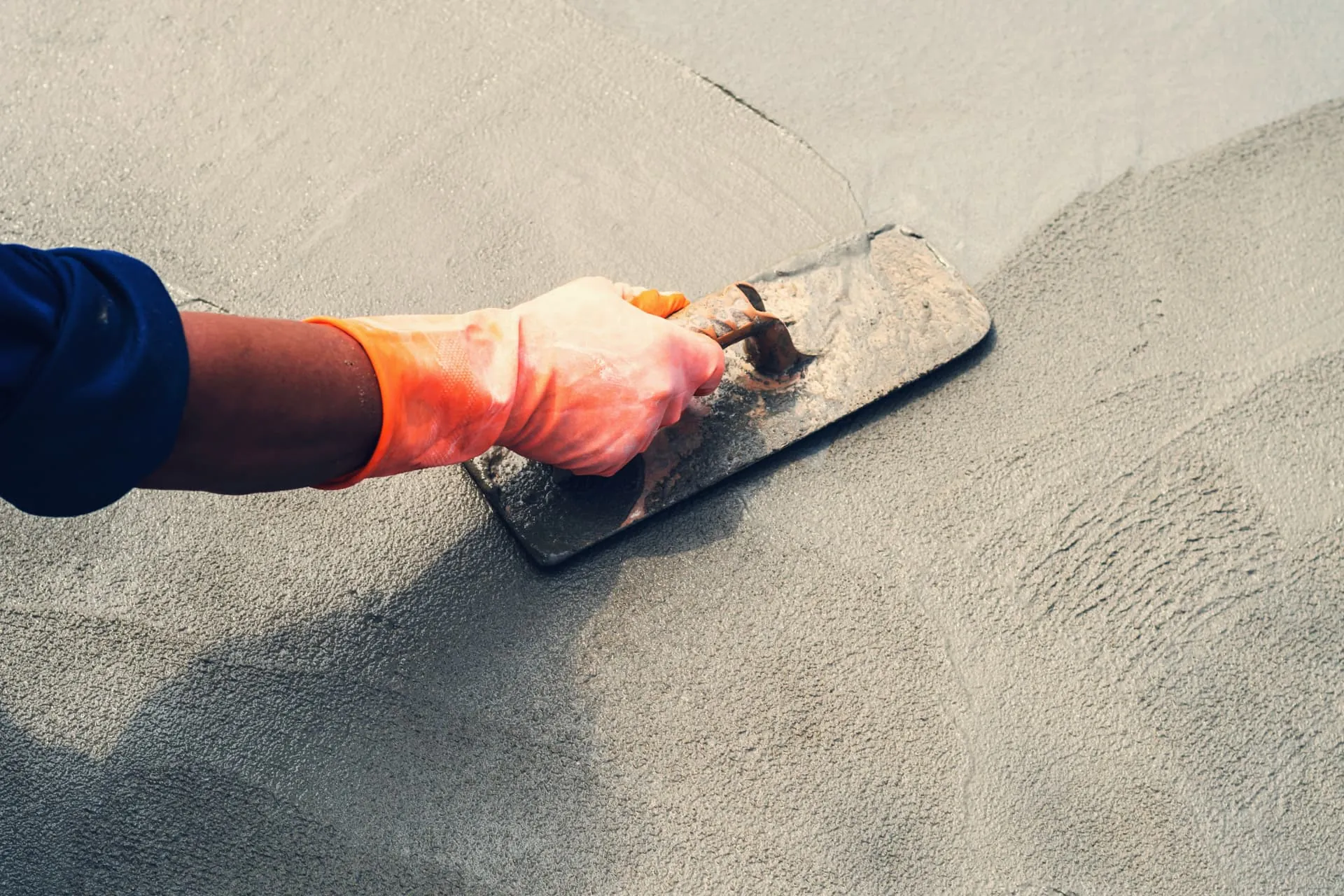 Hand troweling wet shotcrete smooth on a jobsite in Tucson, Arizona
